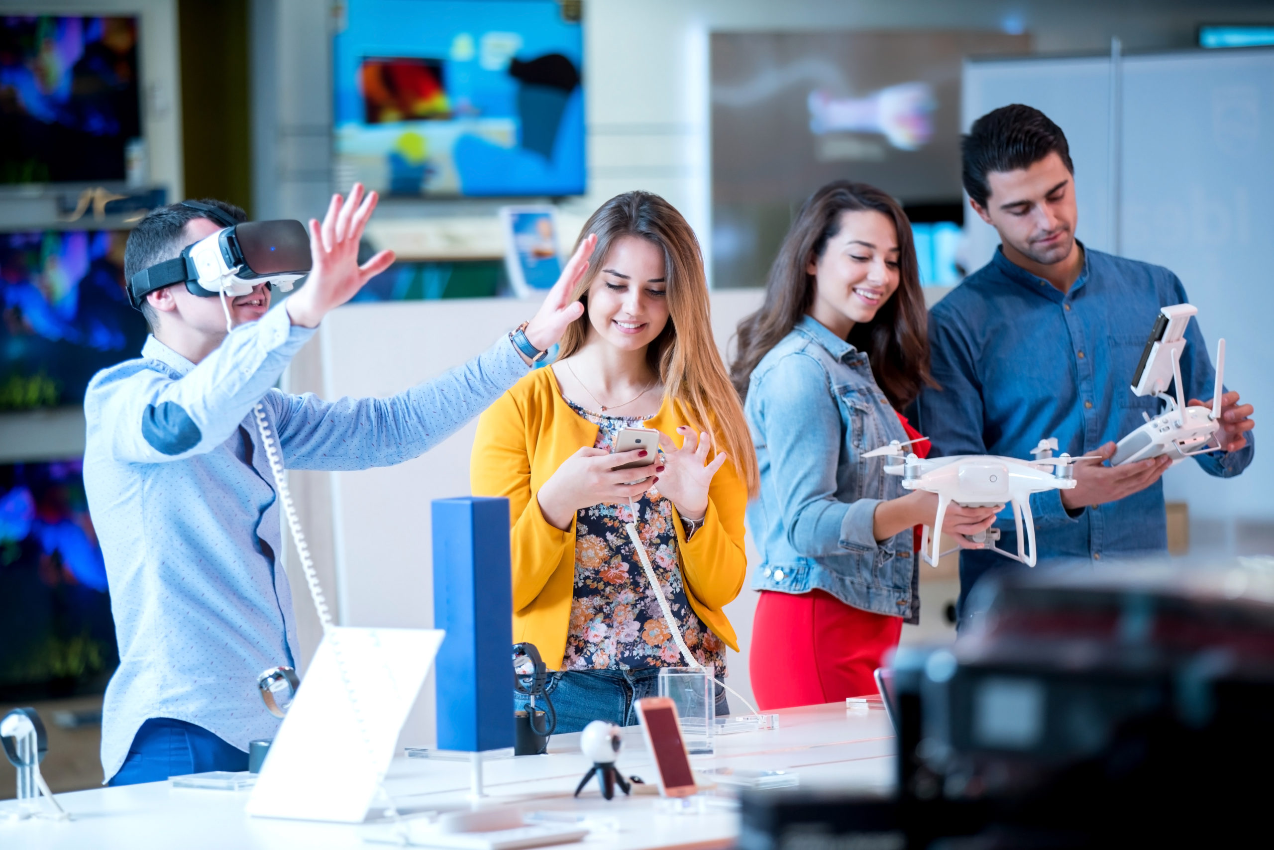 young people having fun testing and buying latest electronics. shopping